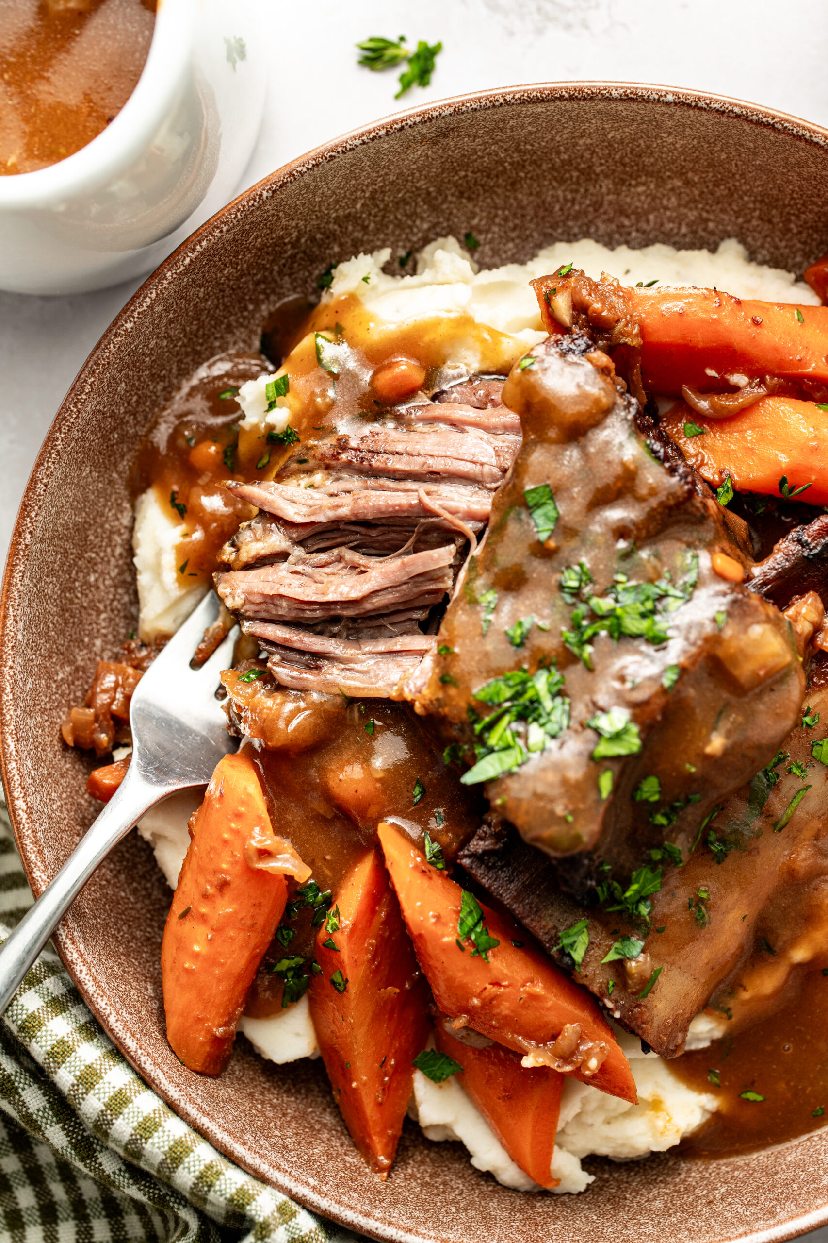 short ribs served in a bowl with a piece taken out
