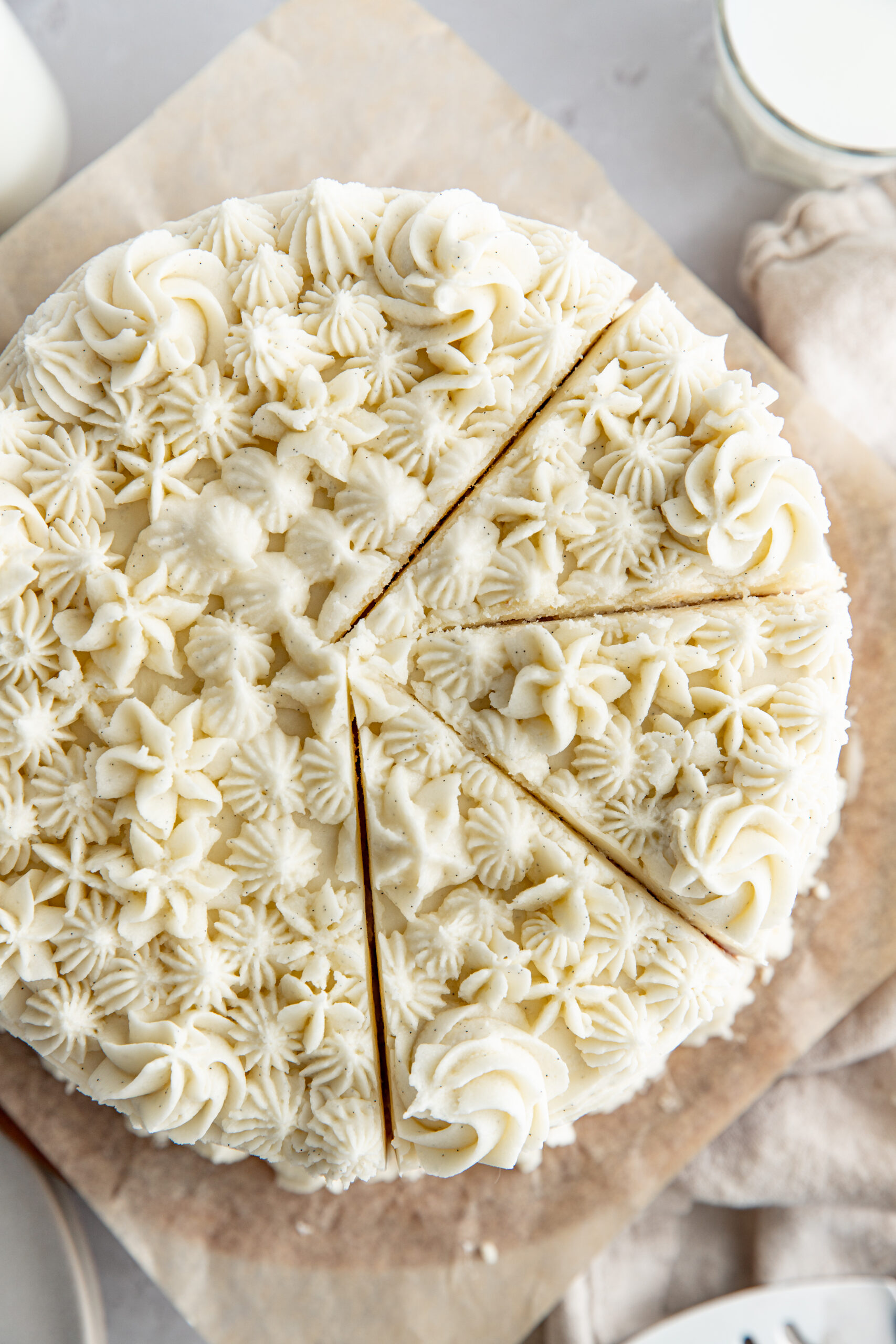 aerial photo of white cake  with 3 slices cut but not removed from the cake