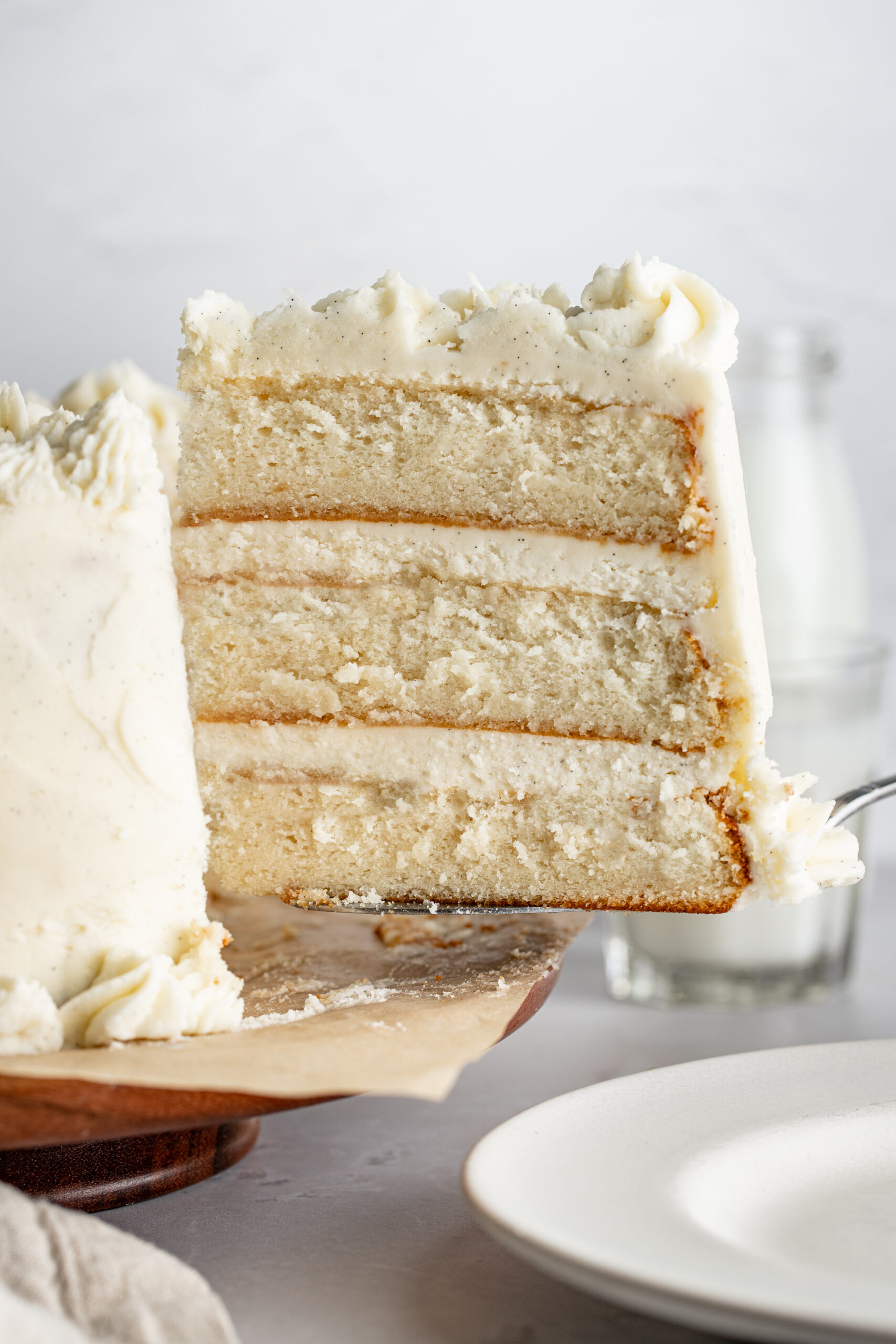 slice of white cake being lifted with a cake spatula