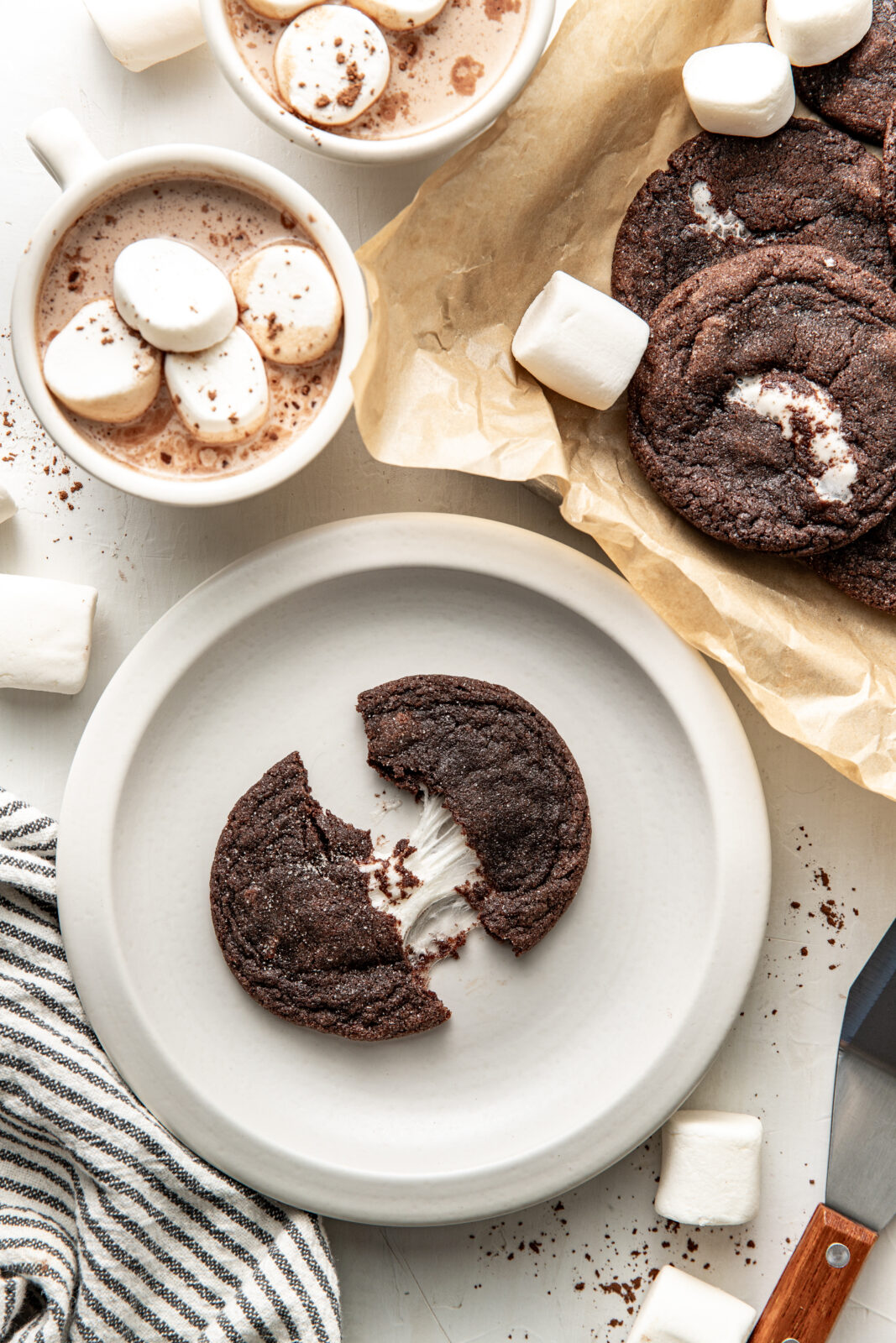cookie on a plate split in half with gooey marshmallow coming out