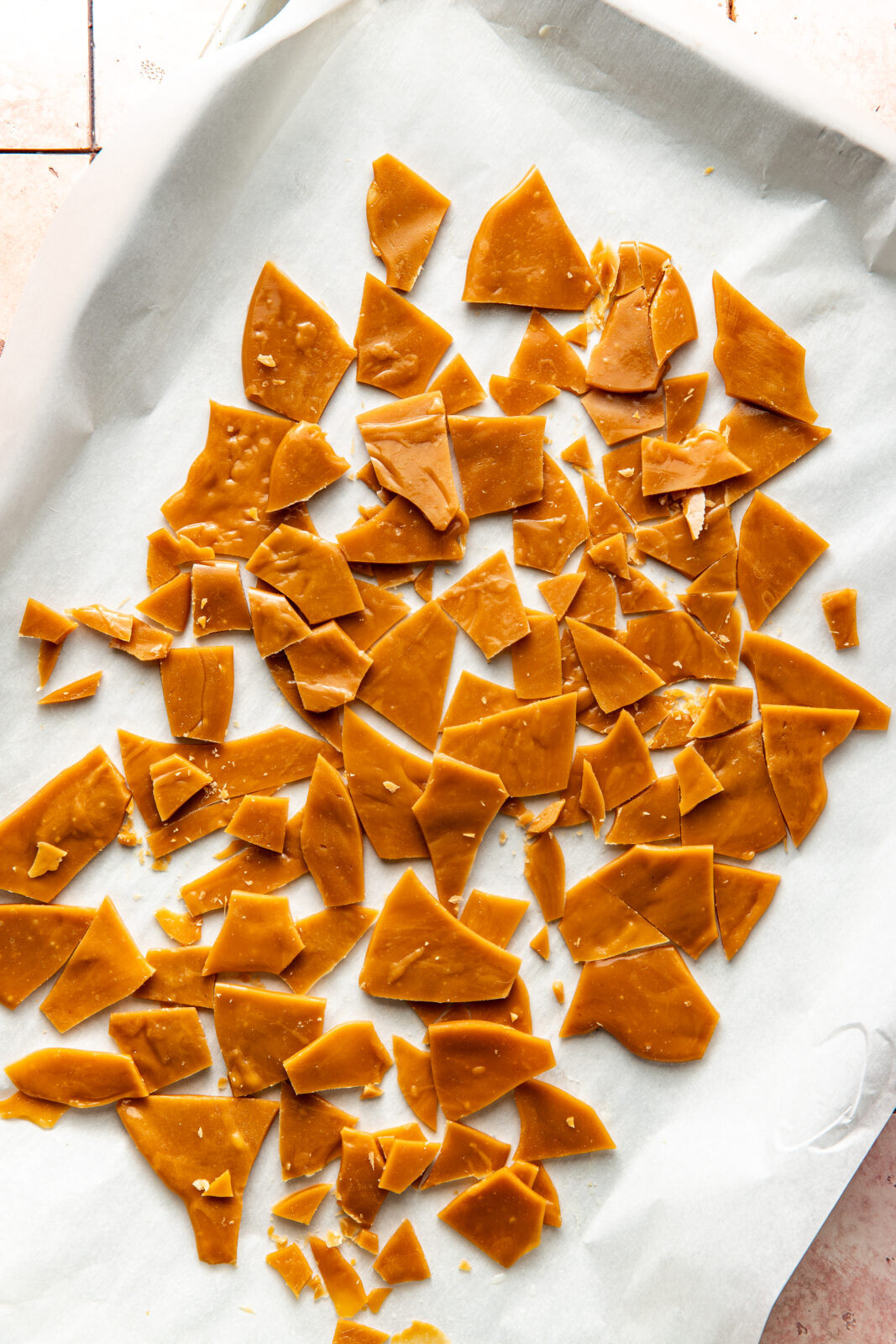 broken toffee on a baking sheet