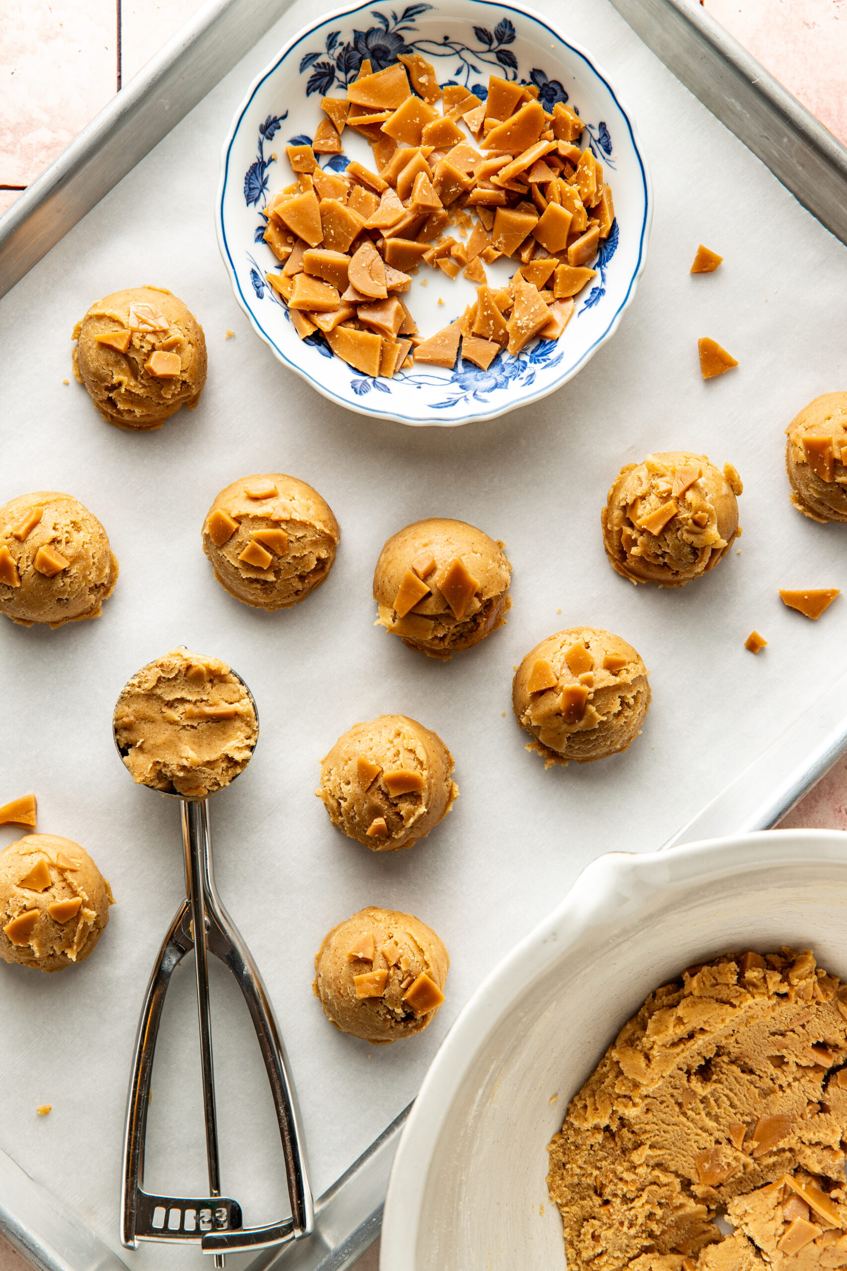 scooped toffee cookie dough balls into a baking sheet