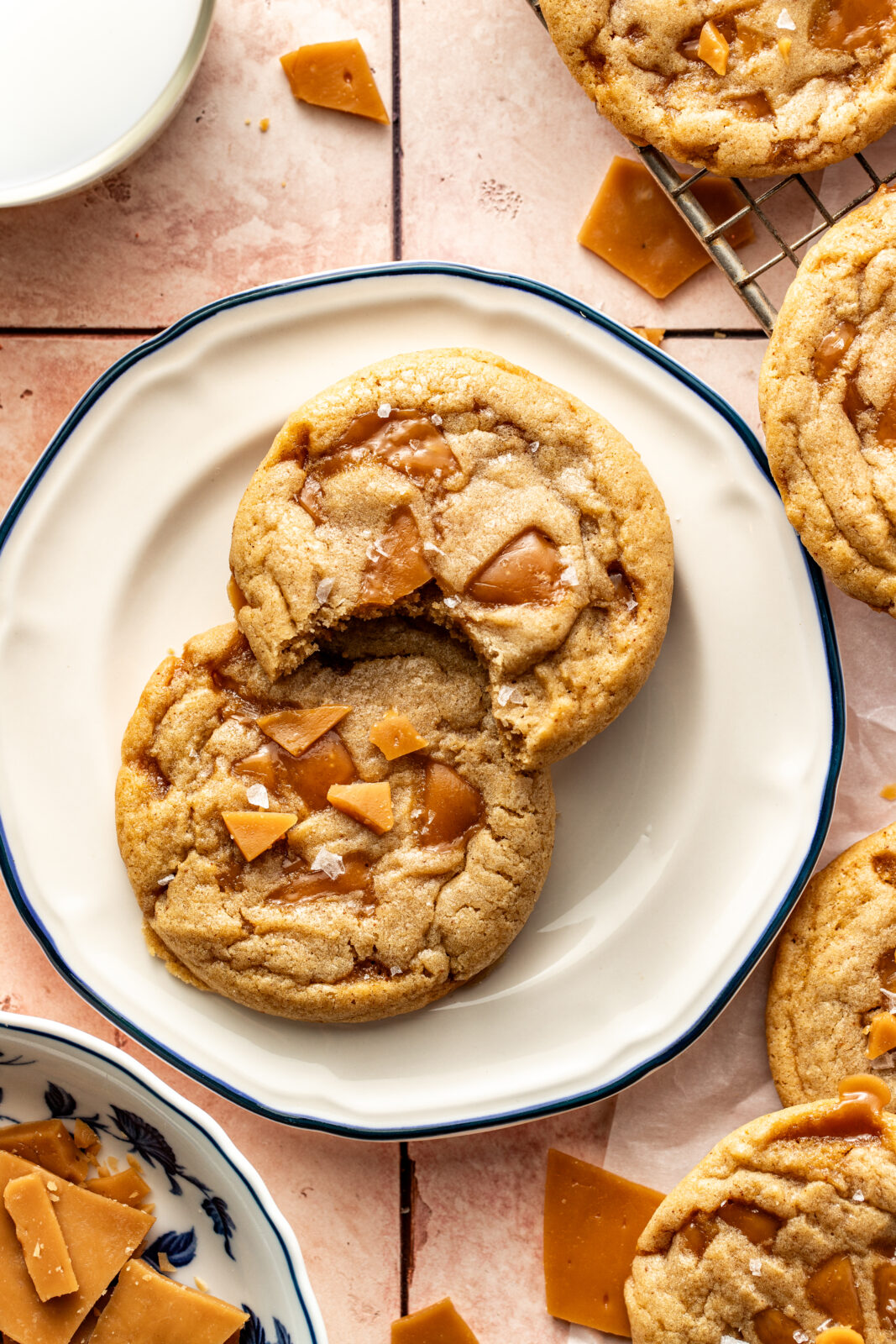 toffee cookies on plate with one having a bite taken out