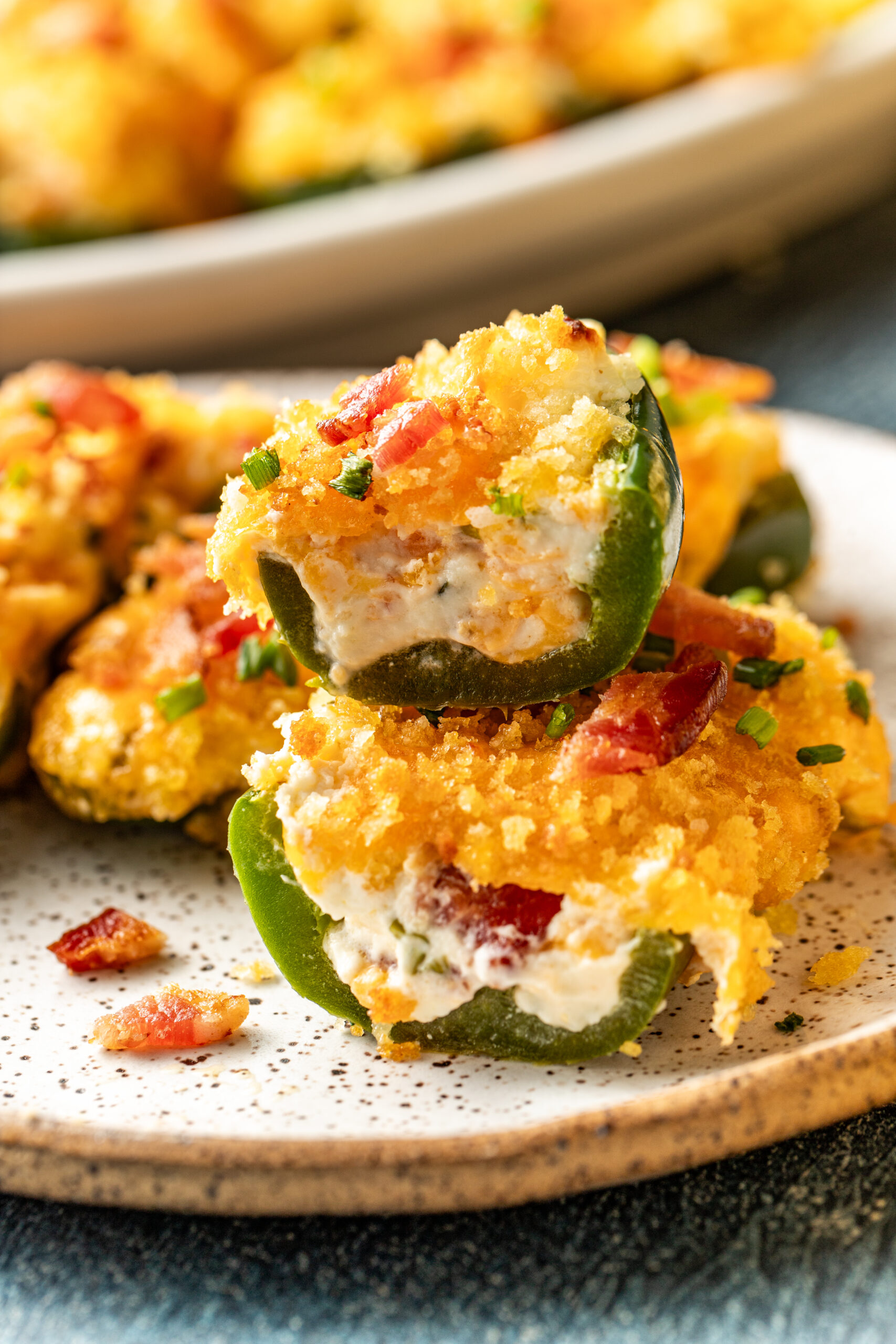 jalapeño poppers on a plate but in half and stacked on each other