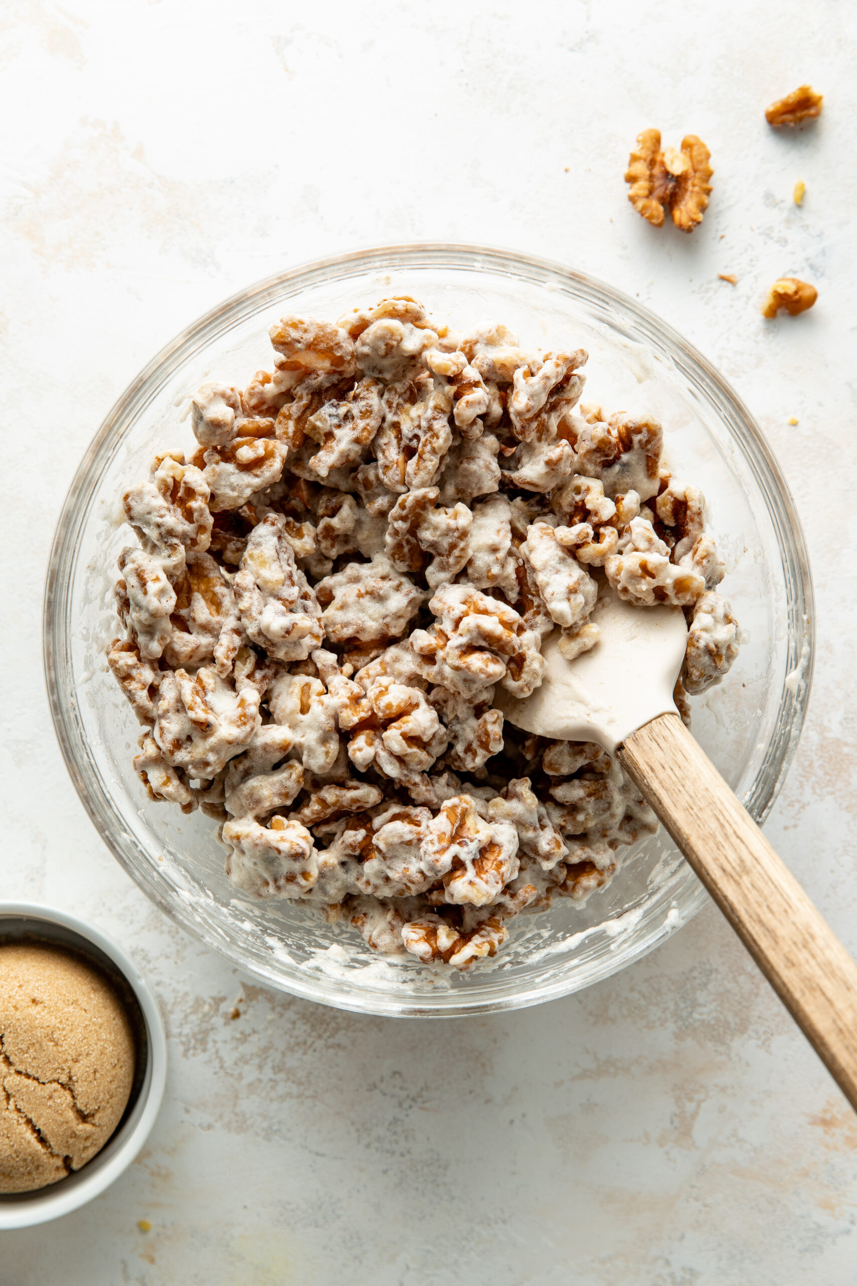 tossed walnuts with whipped egg whites in a bowl