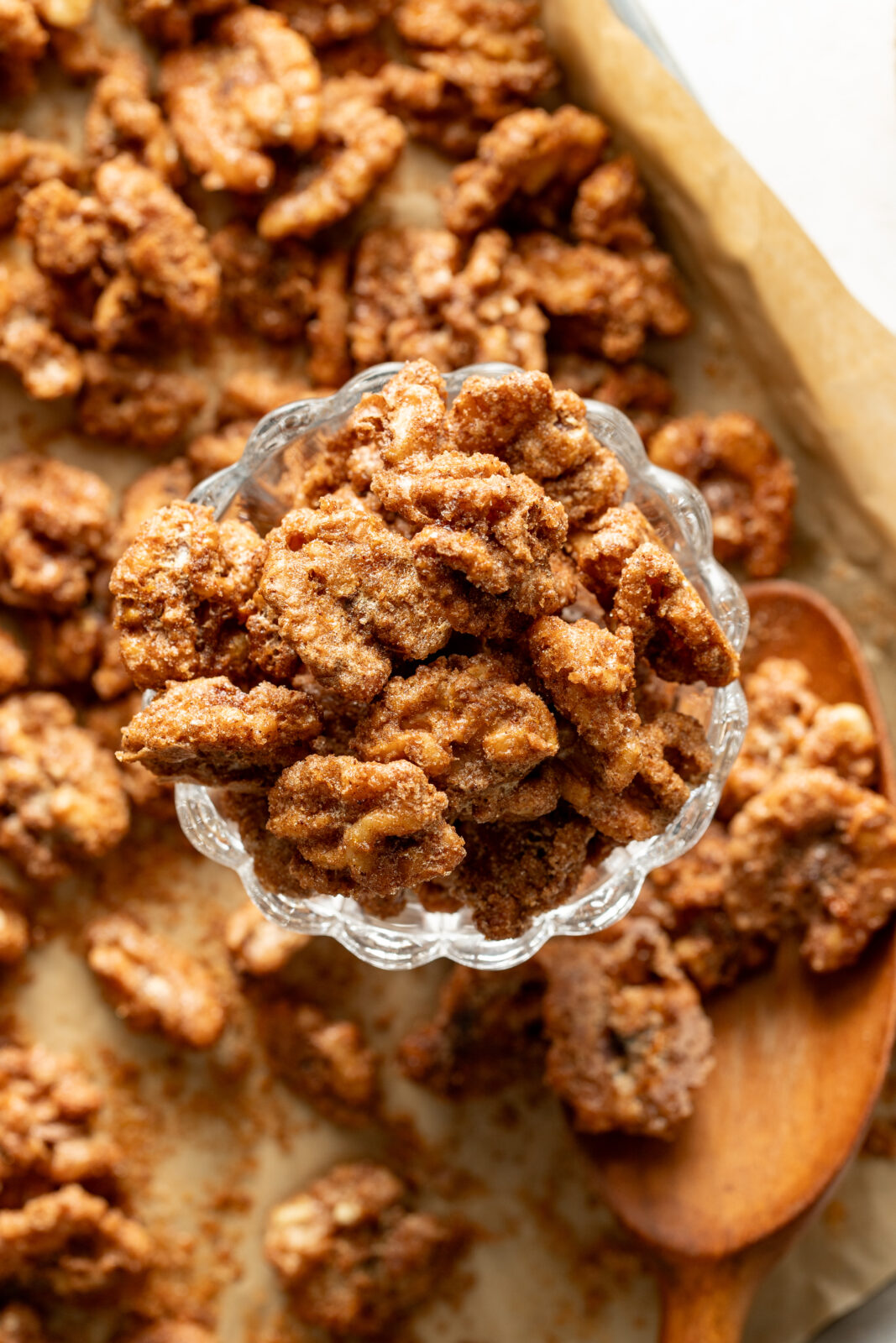 walnuts in a glass jar sitting on a baking sheet