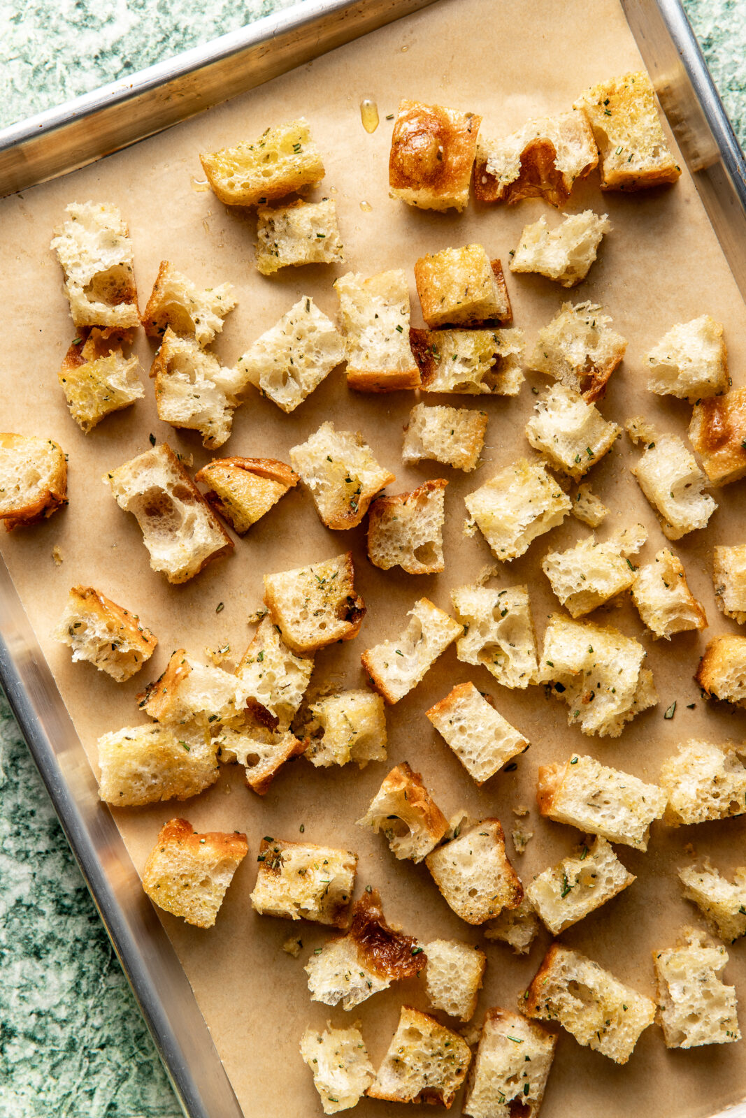 unbaked croutons on a baking sheet