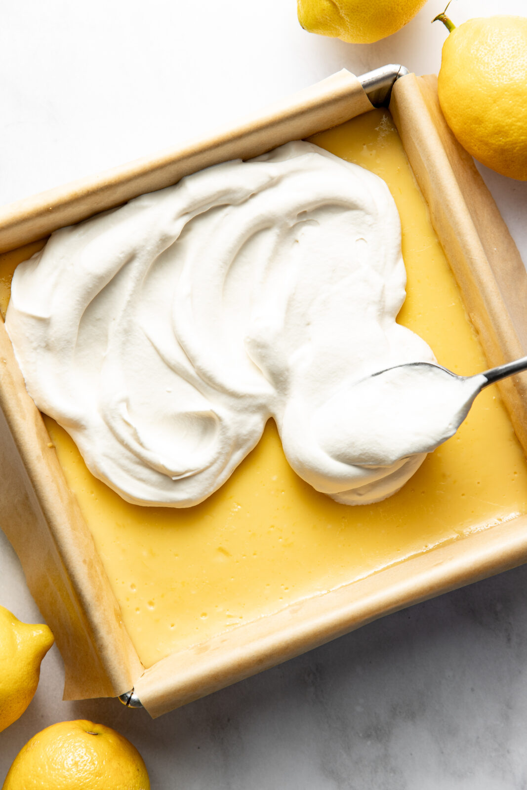 Spread the whipped cream evenly over the lemon bars