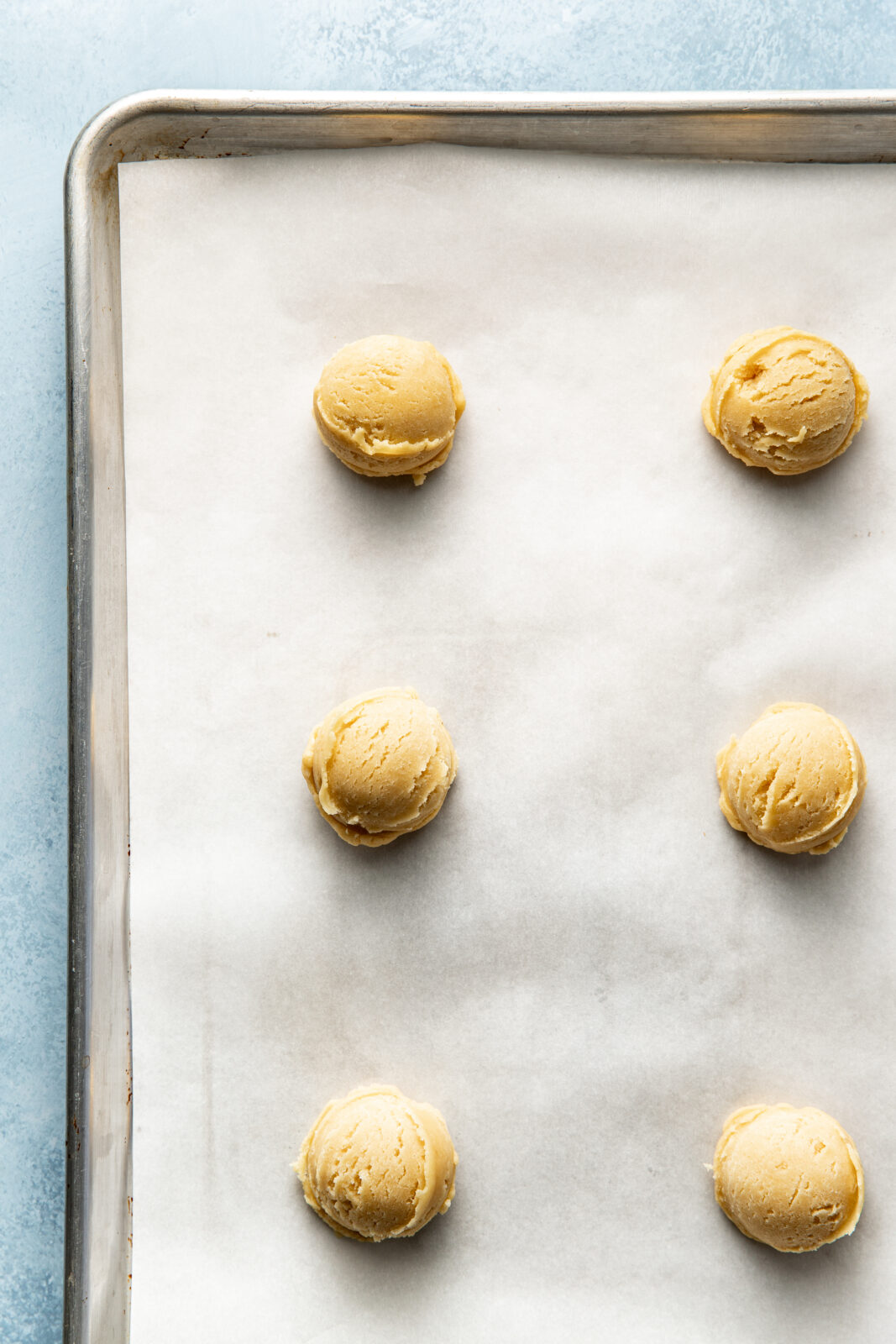 cookie dough balls on baking sheet