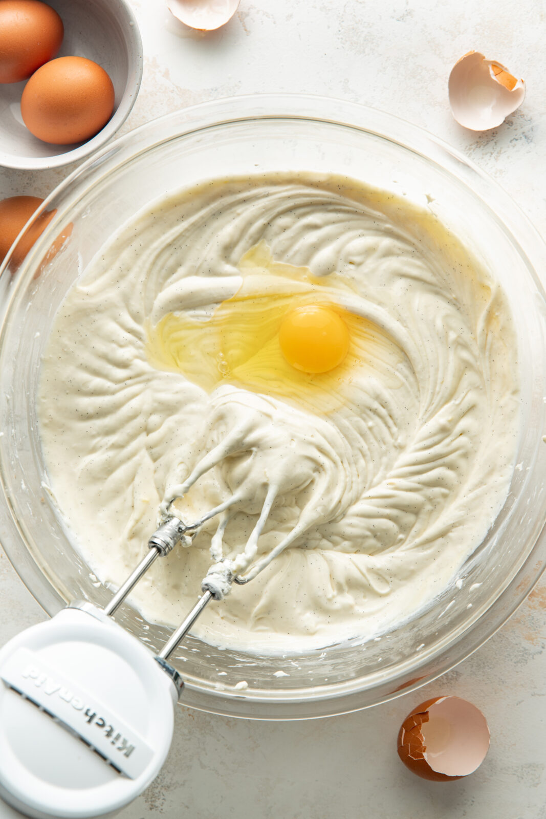 adding eggs to the cheesecake base
