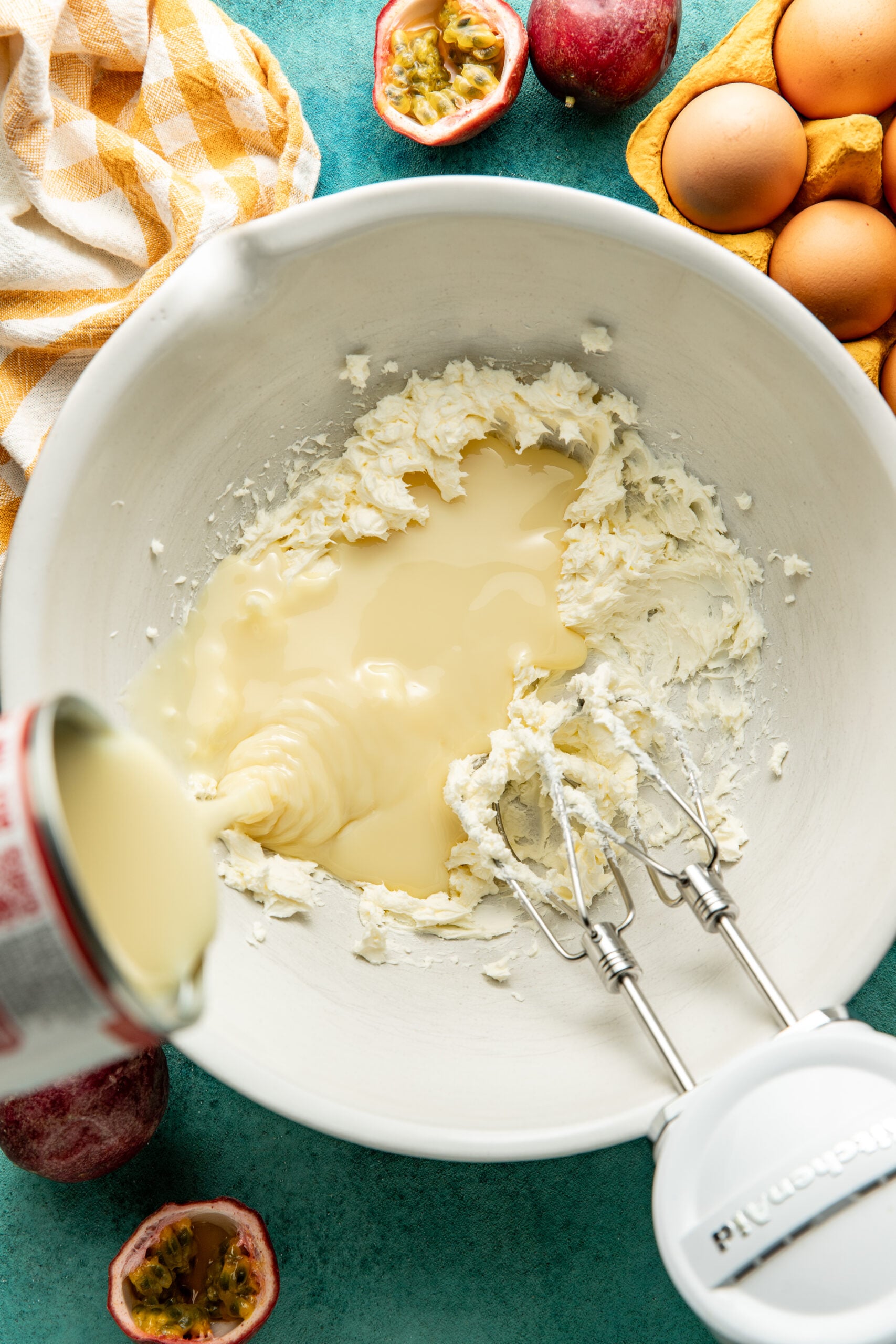 adding sweeten condensed milk to cream cheese